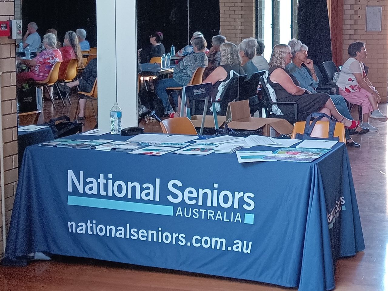 Seniors Forum and Childers Branch Launch Event 8/10/2025.  National Seniors welcome table on the day filled with take home flyers sharing important information for seniors.